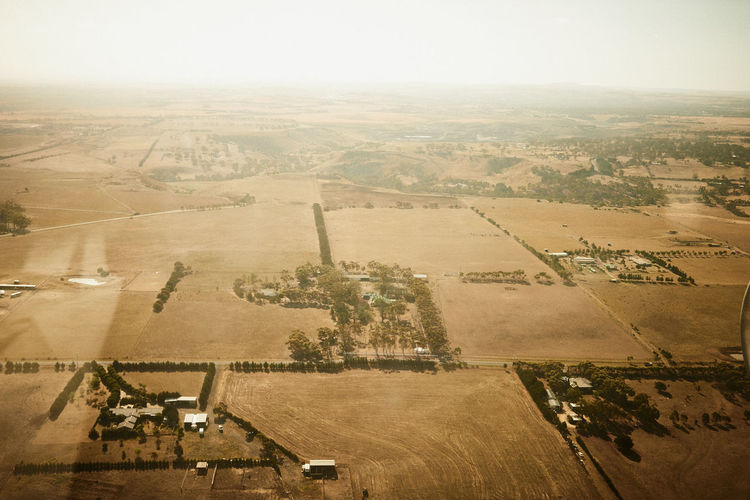 Aerial view of agricultural field against clear sky