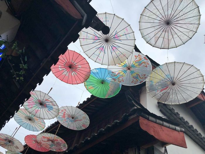 Low angle view of umbrellas for decoration against sky