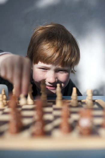 Portrait of boy playing chess