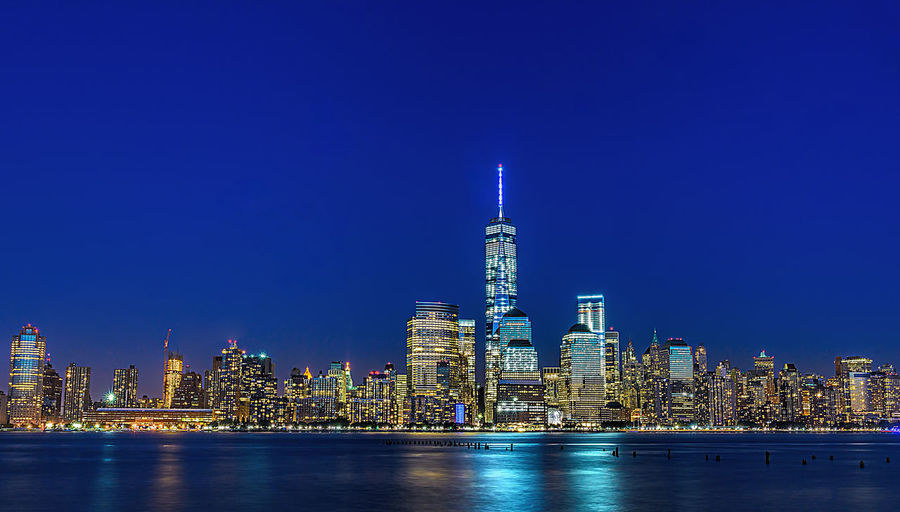Illuminated city at waterfront