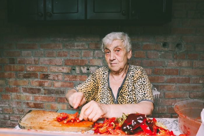 Portrait of senior woman preparing food