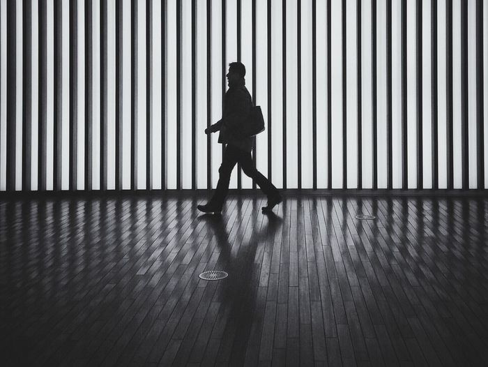 Full length of silhouette man walking in passage