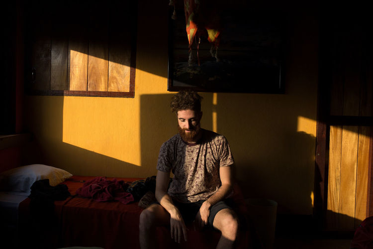 Man sitting in a room in morning light