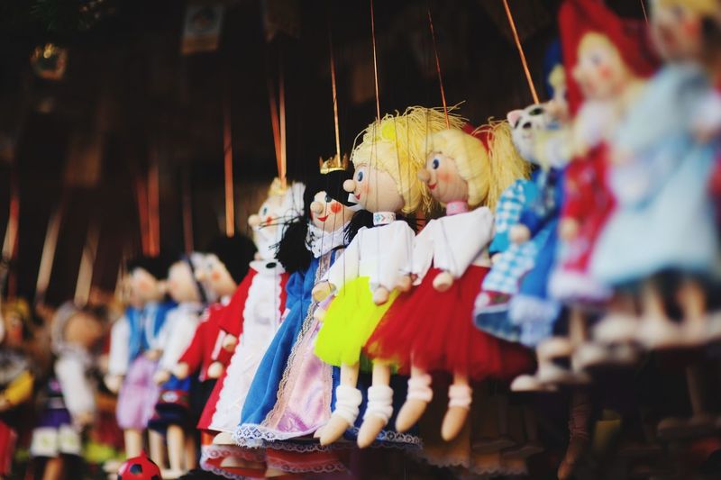Close-up of dolls hanging for sale at market