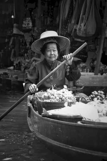 Woman in boat at floating market
