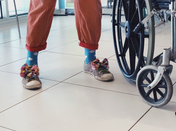 Low section of people standing on tiled floor