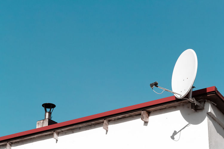 Satellite dish on a roof. and blue sky.