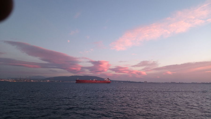 Scenic view of sea against cloudy sky