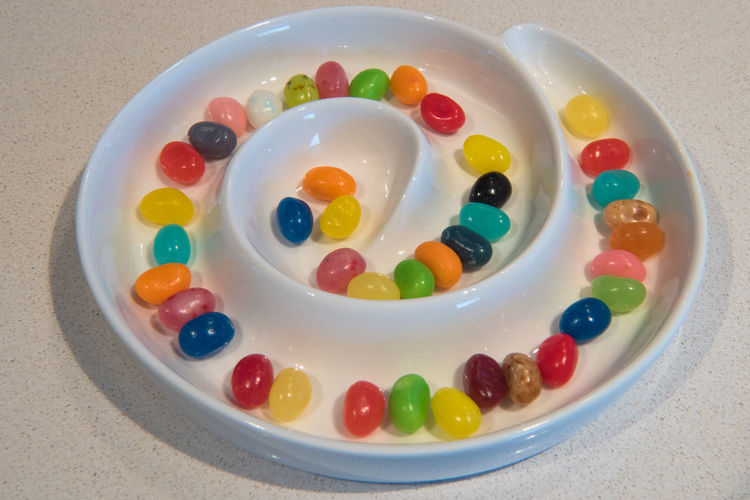 High angle view of multi colored candies in plate