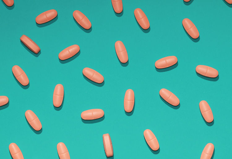 Directly above shot of tablets over colored background