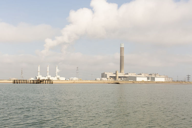 Panoramic view of lpg terminal by sea against sky