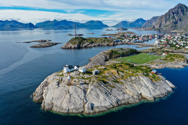 Aerial view of mountains, ocean and a lighthouse in lofoten norway