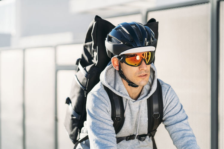 Delivery man wearing sunglasses and cycling helmet