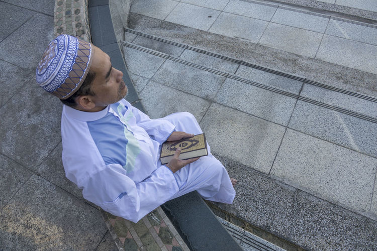 High angle view of man sitting at mosque