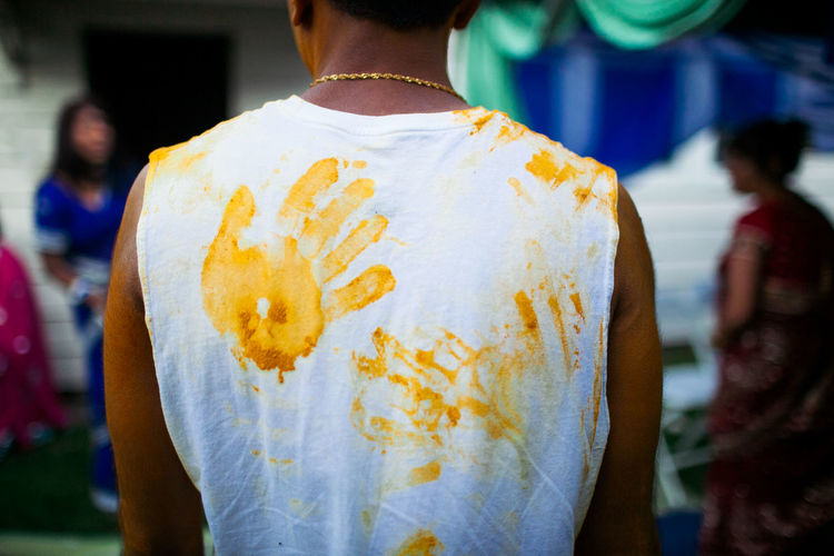 Rear view of man with hand prints on clothes