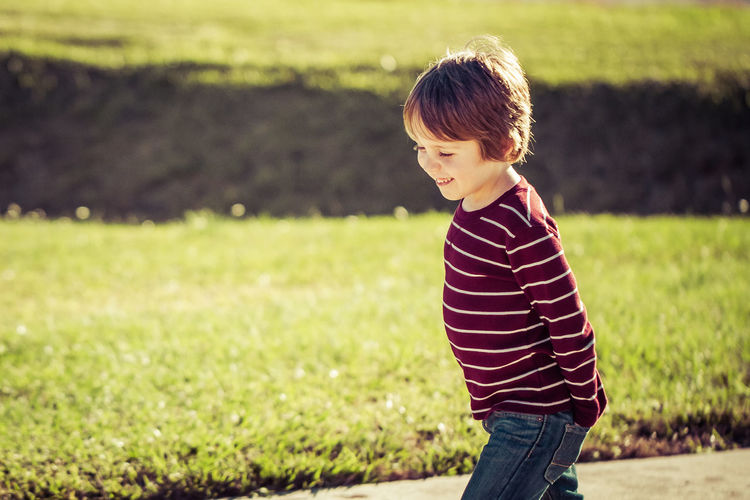 Smiling boy walking on land in park