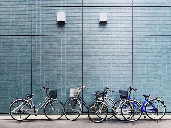 Bicycles against blue wall