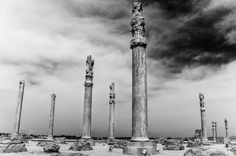 Historic columns of persepolis against sky