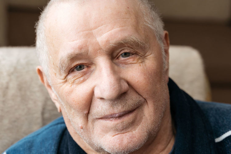 Close up portrait of old smiling man looking at camera