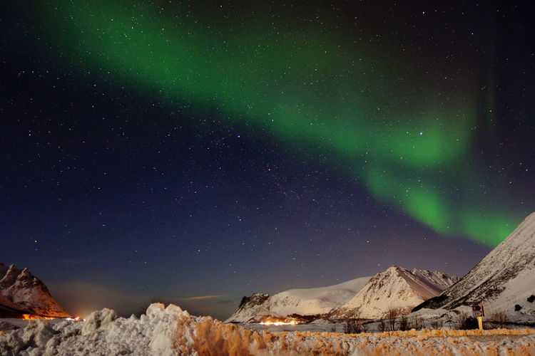 Low angle view of snowcapped mountain against sky at night