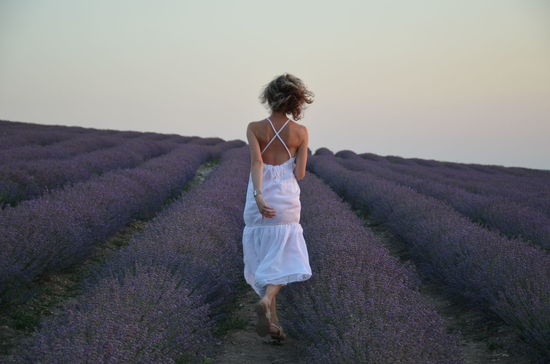 Full length of woman standing on field against sky