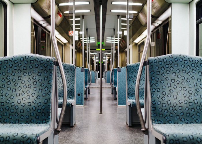 Vehicle interior of illuminated empty metro train