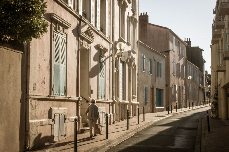 A street in les sables d'olonne with a lady walking in the morning light