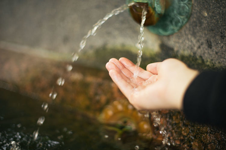 Close-up of hand collecting water in hands
