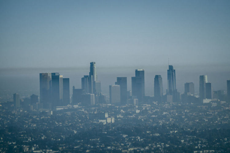 Aerial view of modern buildings in city against sky