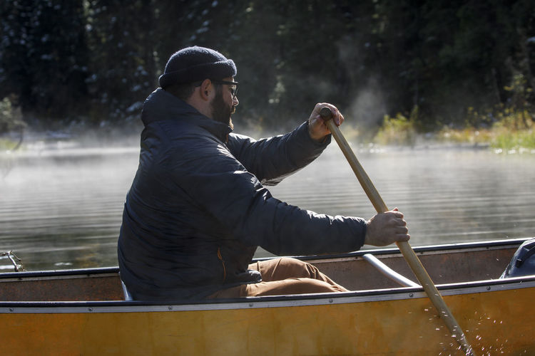 Man sitting on boat in lake