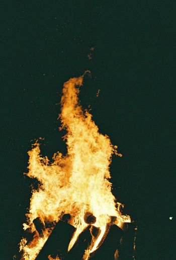 Close-up of fire against sky at night