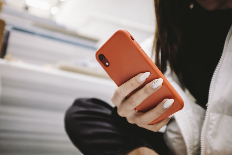 Midsection of man using mobile phone