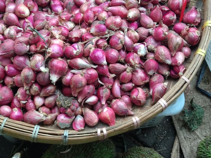High angle view of onion in basket for sale at market stall