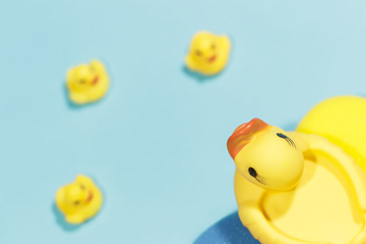 Close-up of yellow toys against blue background