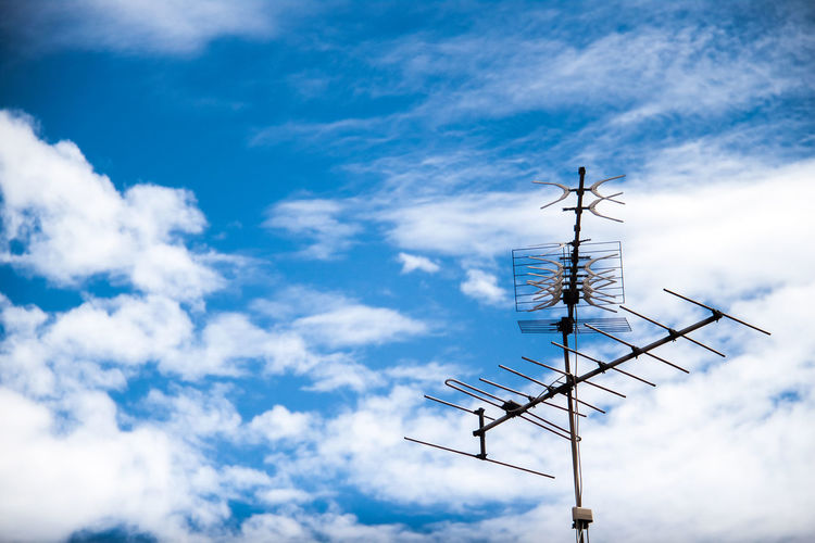 Low angle view of communications tower against sky