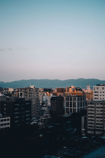 High angle view of buildings in city against clear sky