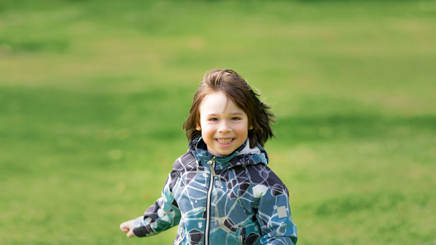 Portrait of smiling boy on grass