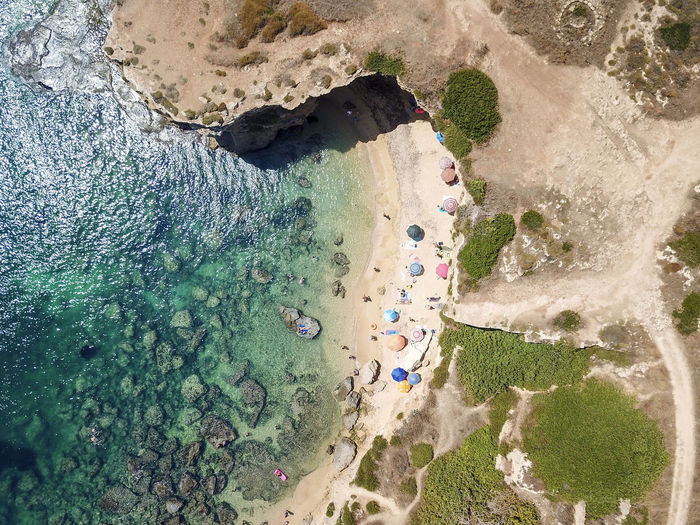 High angle view of people on rocks at beach