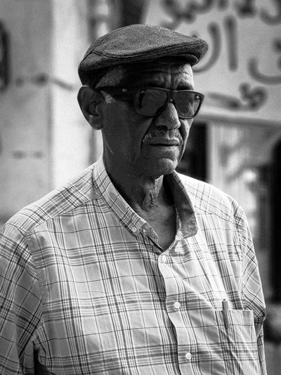 Portrait of old man wearing hat