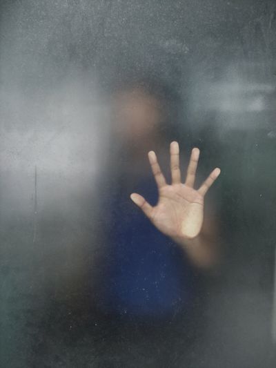 Close-up of hand on glass