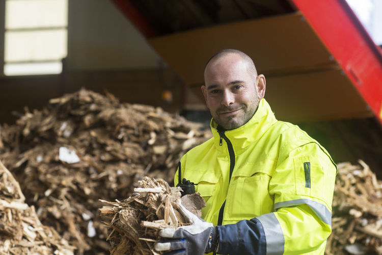 Portrait of content worker at wood recycling yard