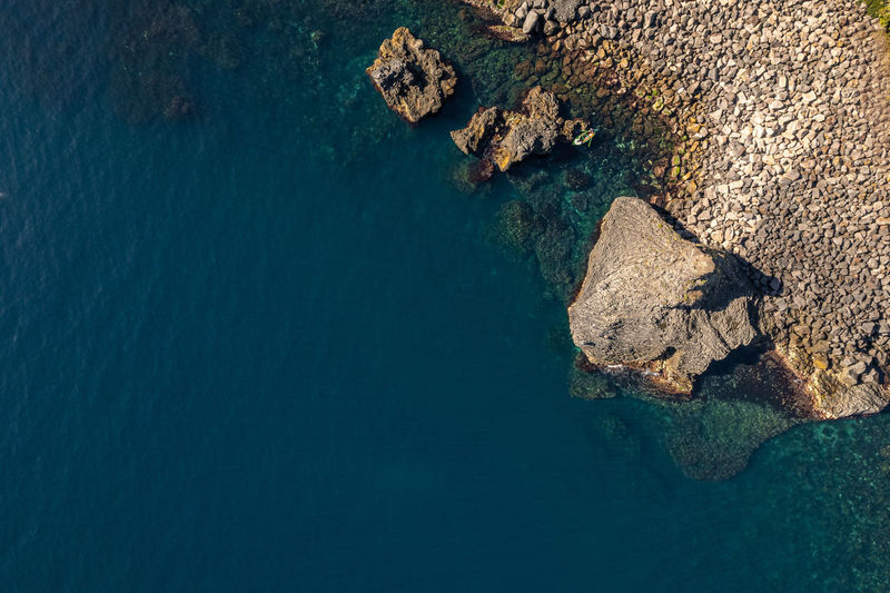 Aerial photo with drone of a volcanic ridge on the sicilian coast of acireale. italy