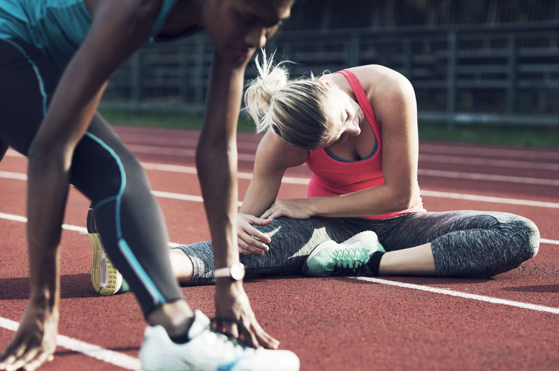 Female athletes exercising on track