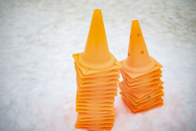 Orange caps in snow. motion limiters. signal triangles. warning signs.