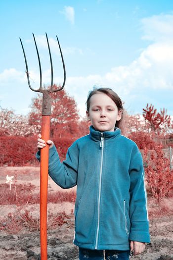 Portrait of young girl with pitchfork