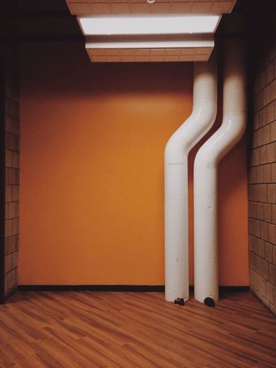Pipes against wall in building
