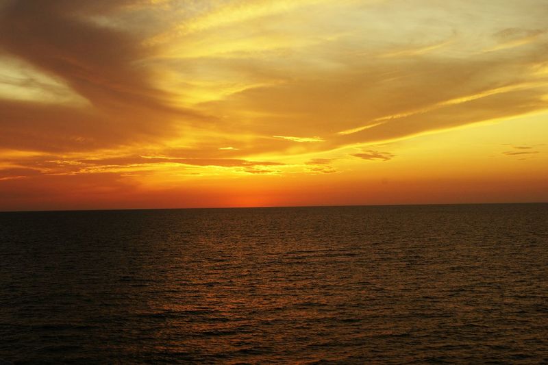 Scenic view of sea against orange sky during sunset