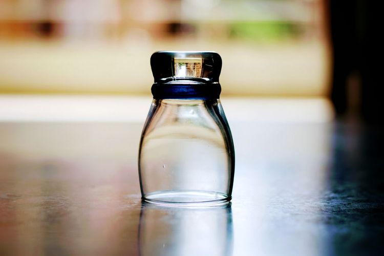 Close-up of glass bottle on floor