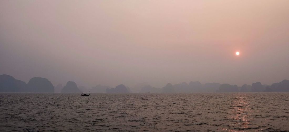 Scenic view of sea against sky at sunset