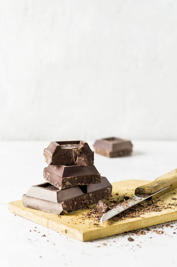 Close-up of chocolate on table against white background